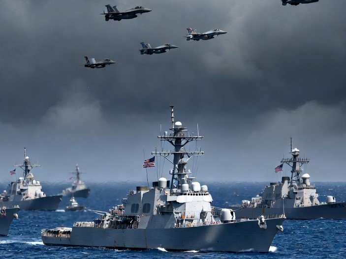 US military warships and fighter jets deployed near Iran amid rising Middle East tensions.