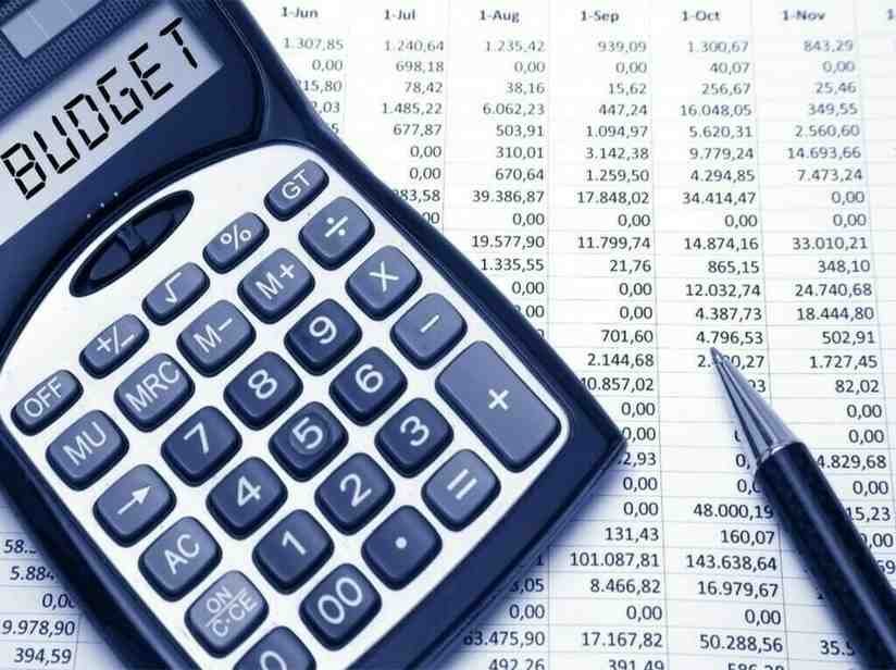 Calculator and financial documents showing governance budget proposals