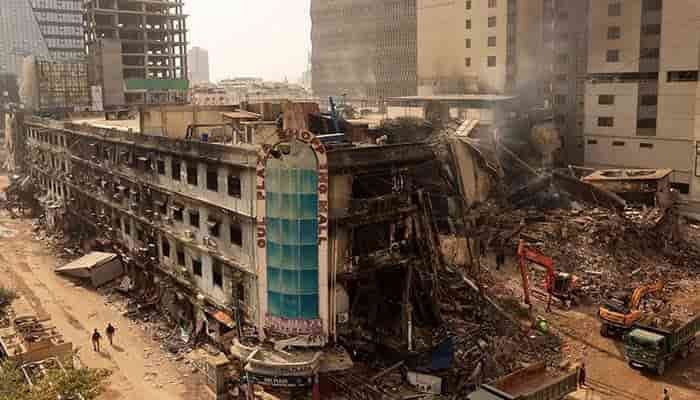 Burnt Gul Plaza building in Karachi after massive fire, showing damaged structure and destroyed shops