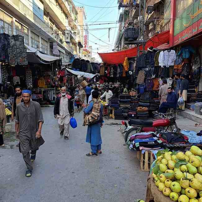 Big News: Market Closing Hours Revised Shops closing at night in a busy Pakistani market under new market timings