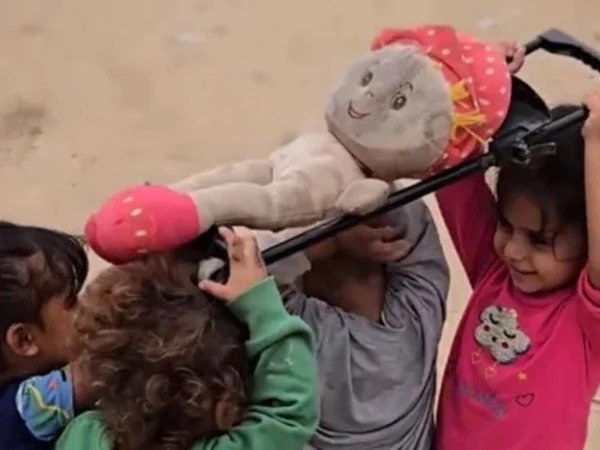 Gaza children playing a funeral game in a refugee camp