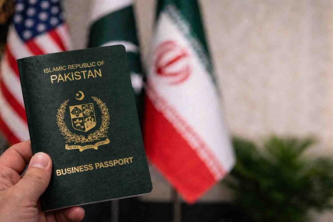 Pakistani business passport held in hand with blurred international flags in the background