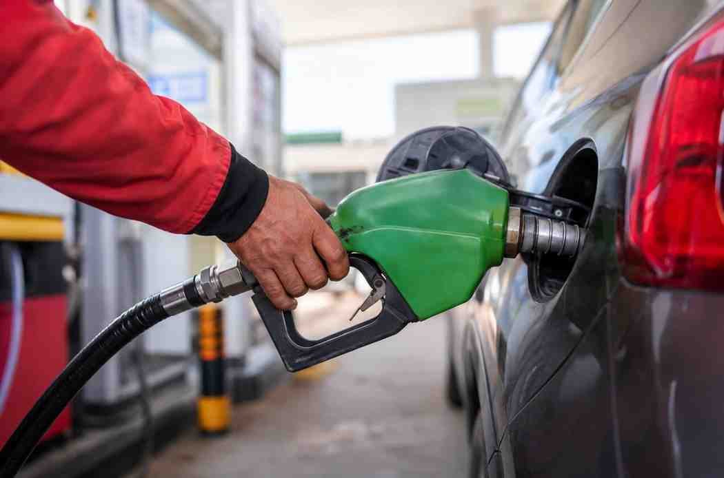 Fuel station worker filling diesel at petrol pump in Pakistan