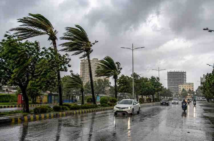 Dark rain clouds and strong winds over a highway during changing weather conditions in Pakistan