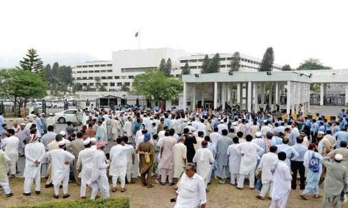 budgetrelie Government employees gather outside Parliament House in Islamabad during a budget-related protest.