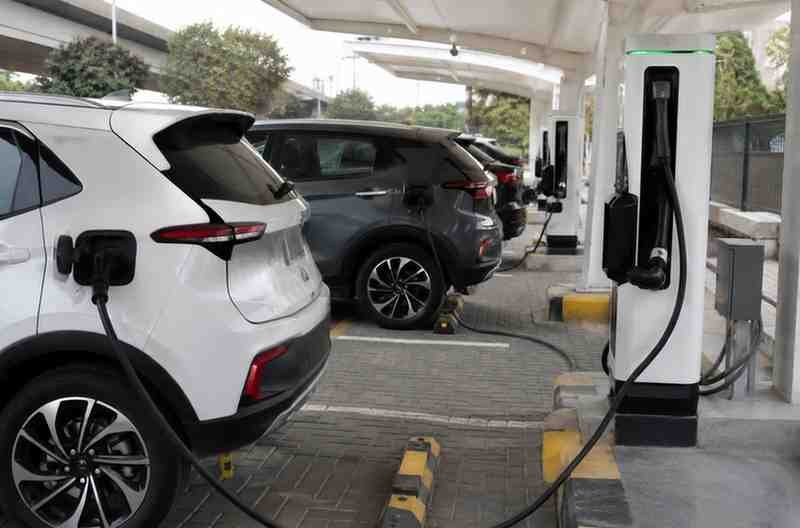 Electric cars charge at a public charging station in Pakistan.
