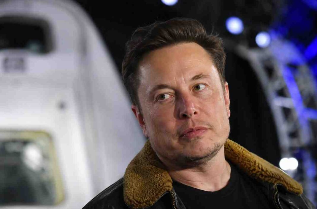 Elon Musk at a SpaceX event amid market value concerns.