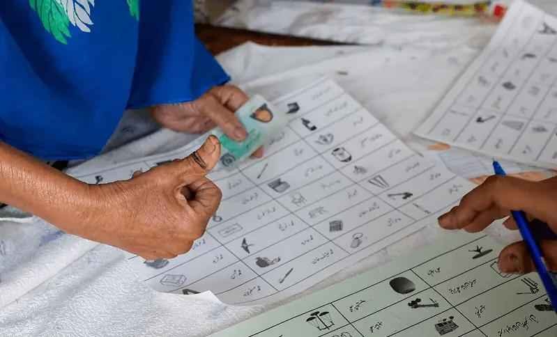 Voter casting a ballot during the Gilgit-Baltistan Elections at a polling station.