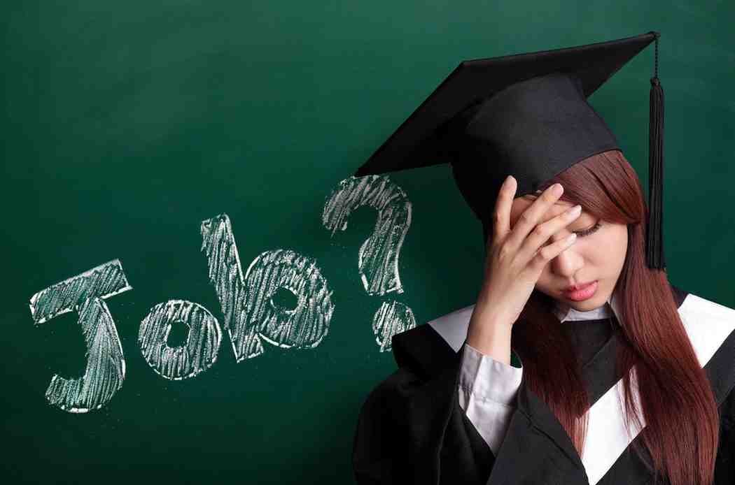 A university graduate looks worried about job prospects despite holding a degree, highlighting modern employment challenges.