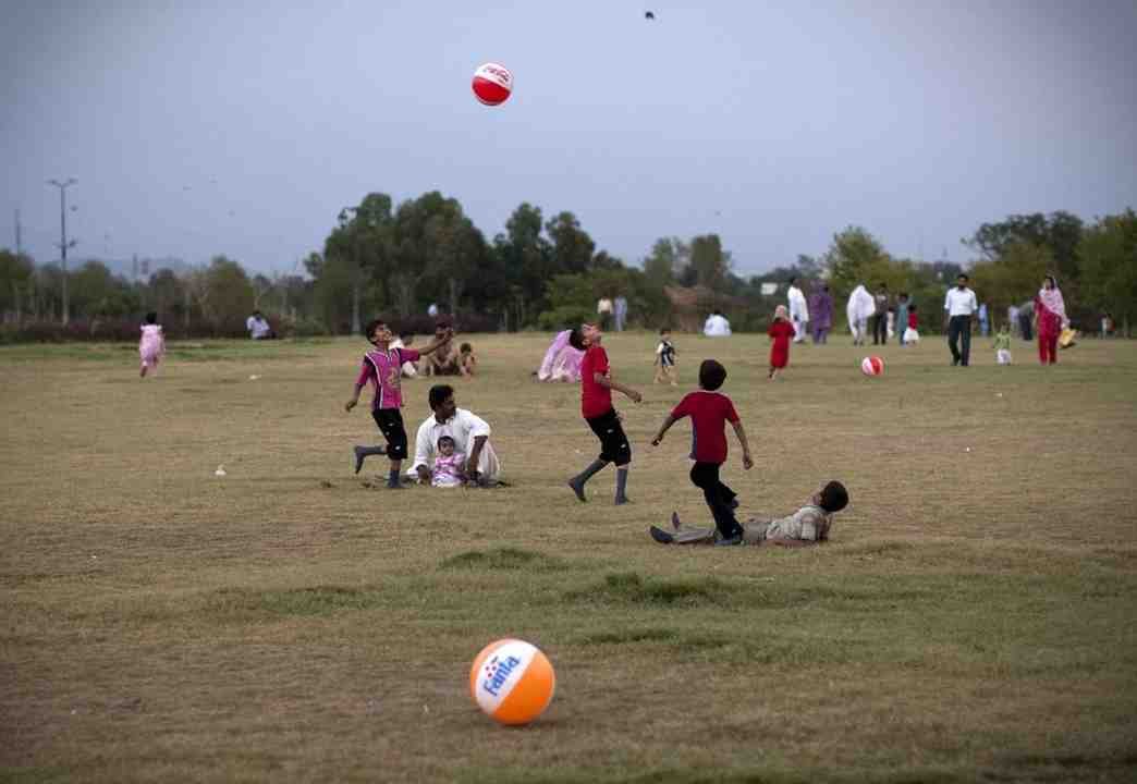 Pakistani children playing freely in an open field during their leisure time.