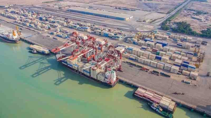 Container ships and cargo operations at a major Iranian commercial port after maritime restrictions were lifted.