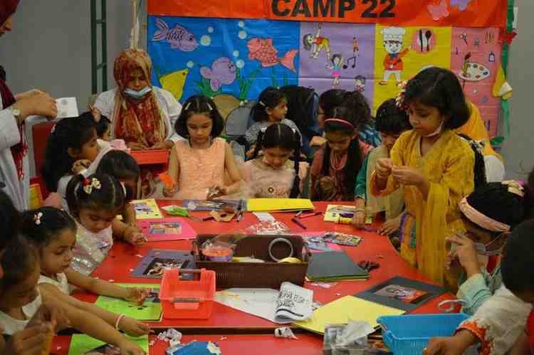 Pakistani children taking part in arts and crafts activities during a summer camp session