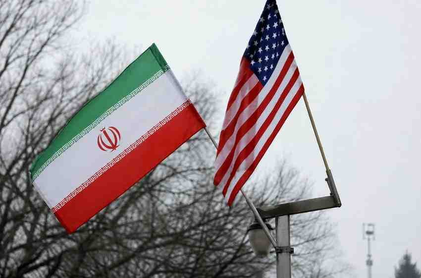 Iranian and US flags displayed side by side amid rising diplomatic tensions.