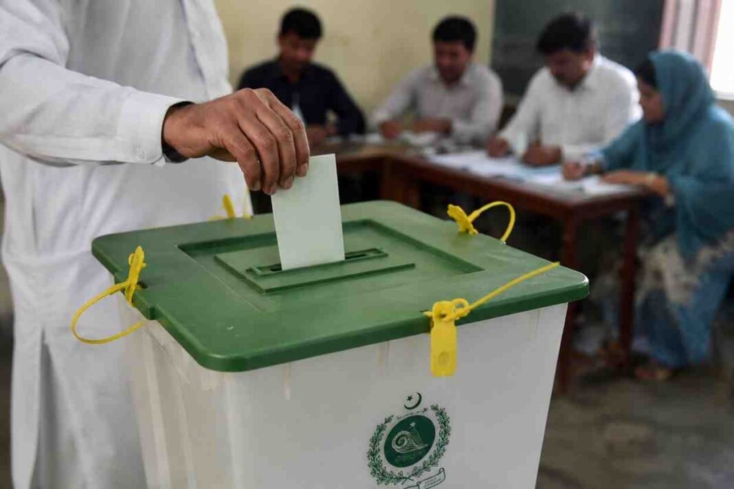 Voter casting a ballot during the Azad Kashmir elections.