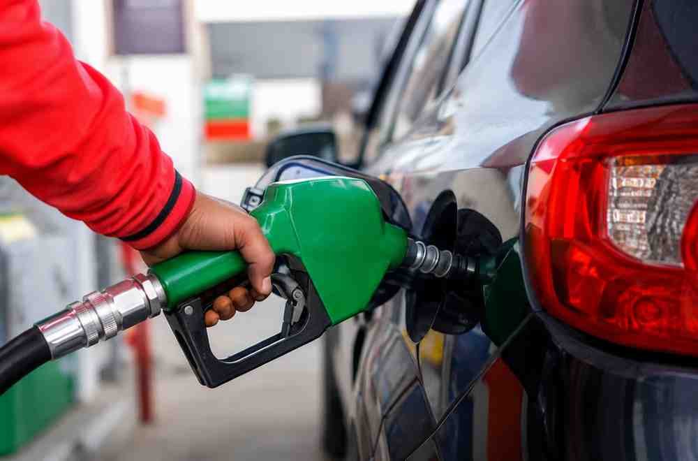 Person refueling a car at a petrol station in Pakistan.