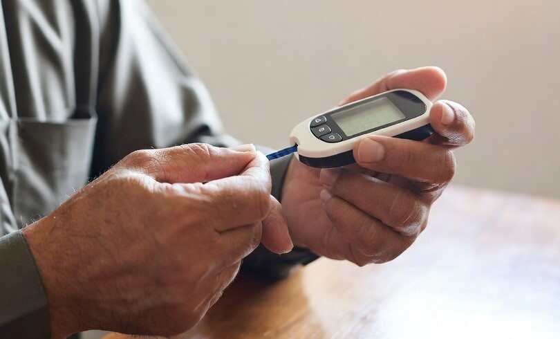 Why Diabetes Is Increasing in Pakistan: 10 Major Reasons Pakistani adult checking blood sugar with a glucometer to monitor diabetes at home.