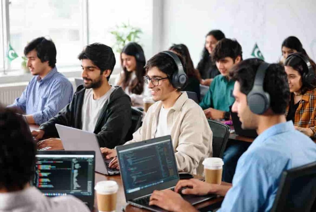 pakistan genZ and freelancing (1) Young Pakistani freelancers working remotely on laptops, representing the rise of freelancing among Pakistan's Gen Z and the growing digital economy.