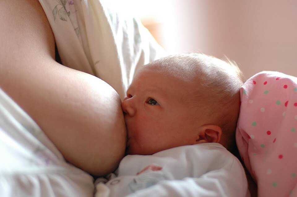 Breastfeeding Breaks at Work: Your Rights Explained Mother breastfeeding her baby — breastfeeding breaks at work