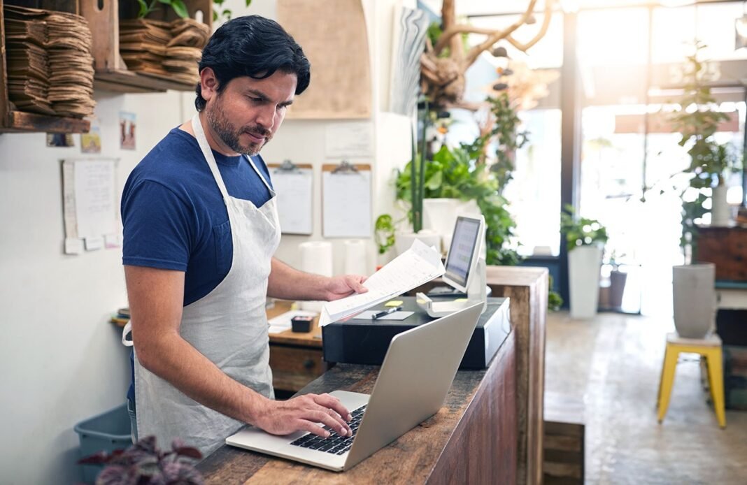 Business Bank Accounts Compared: What Owners Should Know in 2026 Small business owner working on a laptop