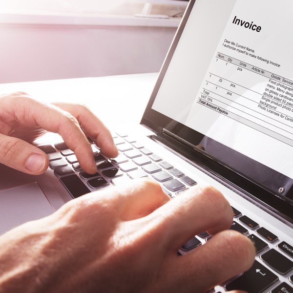 Freelance Invoicing and Payment Tools: A 2026 Guide Freelancer reviewing an invoice on a laptop