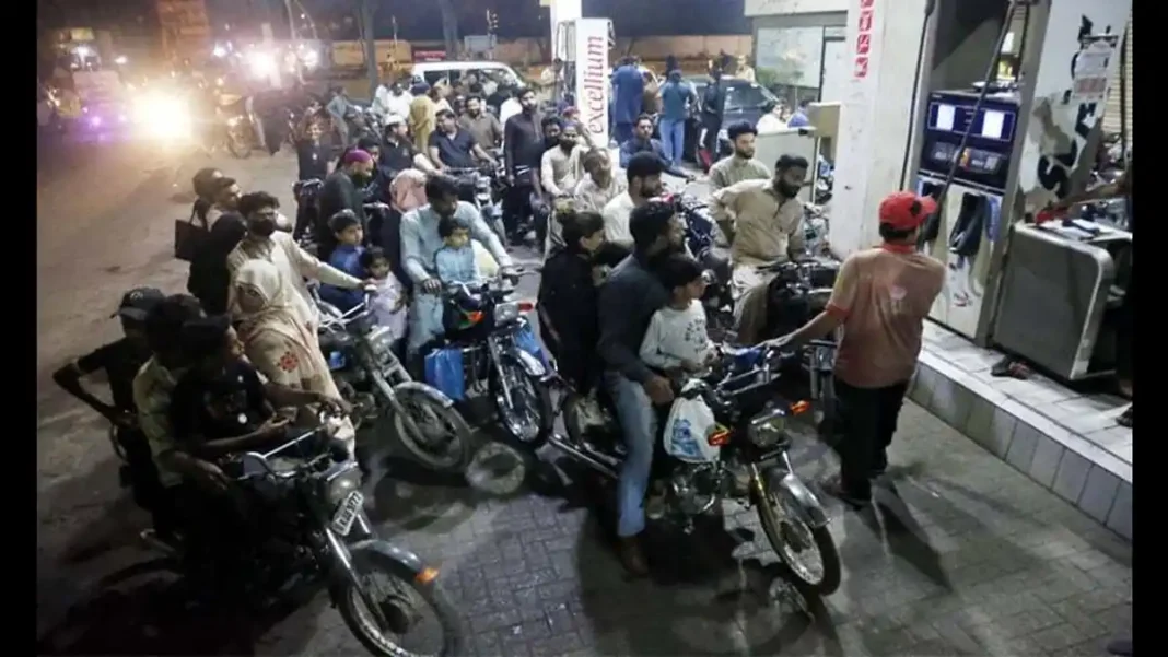 OGRA AI Fuel Supply Monitoring in Pakistan Motorists queue at a petrol station at night — OGRA AI fuel supply monitoring