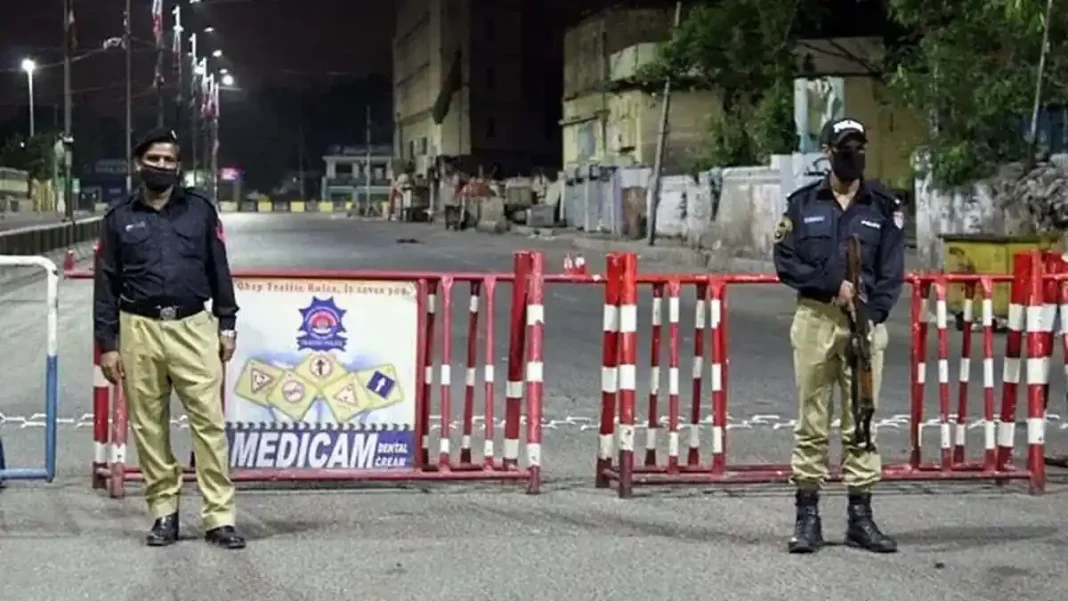 Section 144 Imposed in Karachi, Gatherings of More Than Five People Banned Till October 20 Section 144 imposed in Karachi: police officers stand guard behind red road barriers on an empty Karachi street at night
