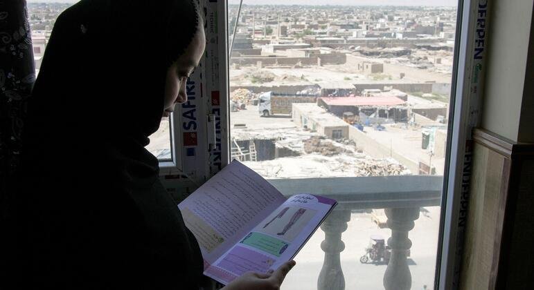ICC Unseals Arrest Warrants for Four Taliban Leaders Over Gender Persecution ICC arrest warrants: Afghan girl reading at home amid the Taliban's ban on girls' education