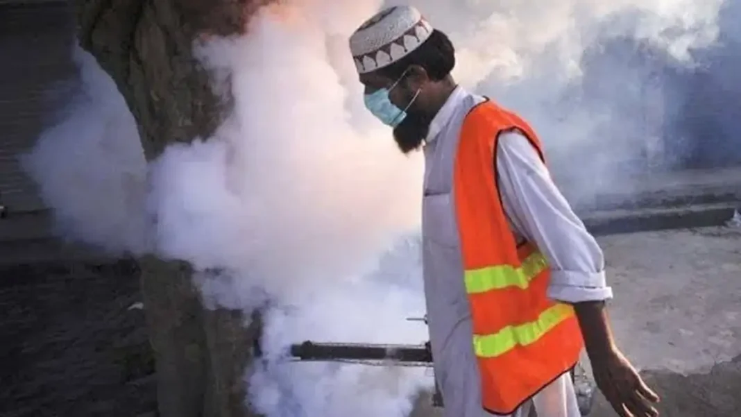 Rawalpindi Restores Jobs of 2,000 Dengue Workers A dengue worker in protective gear fogging a street after dengue workers restored