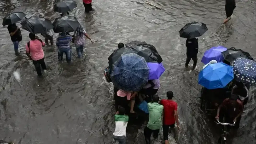 UN Warns Climate Change May Force Millions to Move in South Asia Commuters wade across a waterlogged street in Kolkata after heavy monsoon rains, illustrating South Asia climate displacement risks