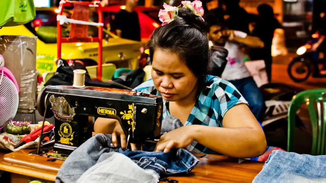 Home-based workers trapped in exploitation as wages freeze at Rs50 an hour A woman sewing at her machine; home-based workers Pakistan wages can be as low as Rs50 an hour
