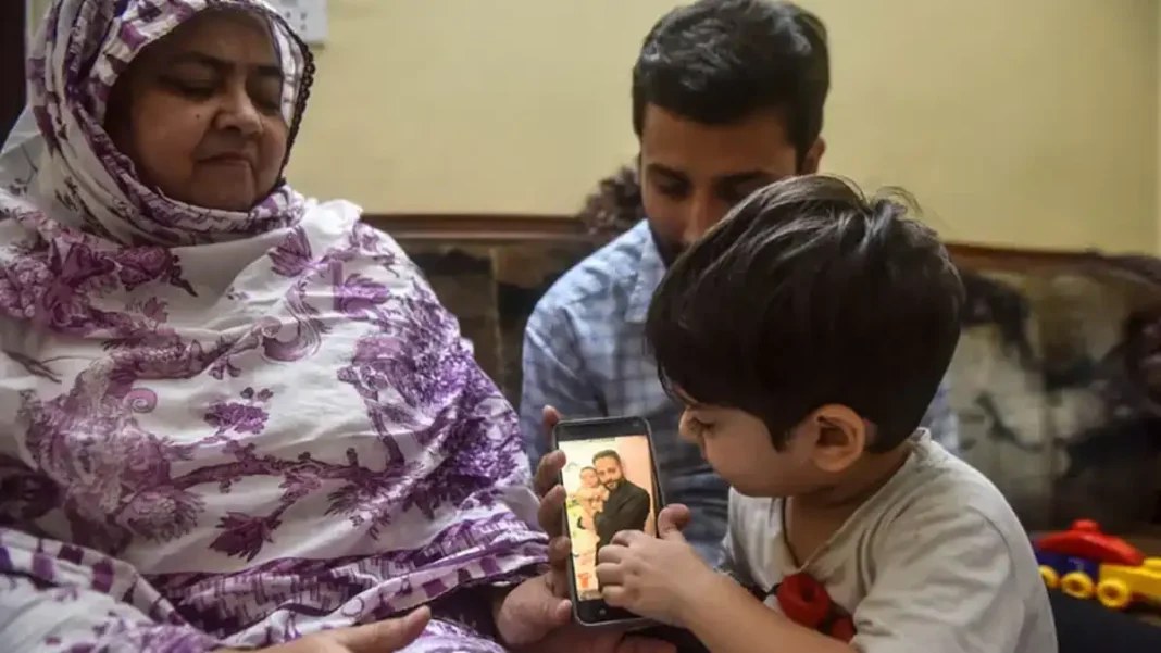 Family of El Gaia Engineer Hammad Obaida Waits for His Remains as DNA Testing Delays Repatriation Hammad Obaida remains: the engineer's mother and three-year-old son look at his photograph on a phone at their Karachi home