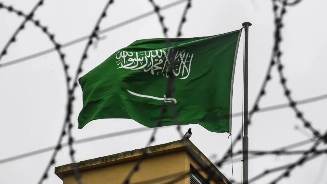 Saudi Arabia Executes Pakistani Man Convicted of Drug Smuggling Saudi Arabian flag behind barbed wire as a Pakistani executed in Saudi Arabia for drug smuggling