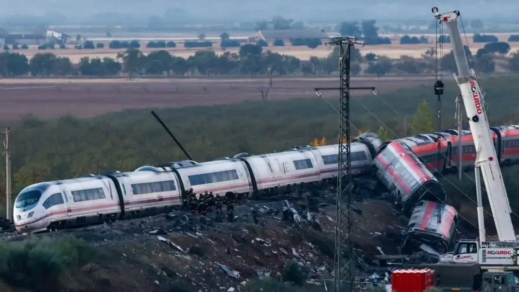 Spain Train Crash Toll Revised to 69 Derailed carriages and a crane at the Spain train crash site near Urda - Spain train crash toll