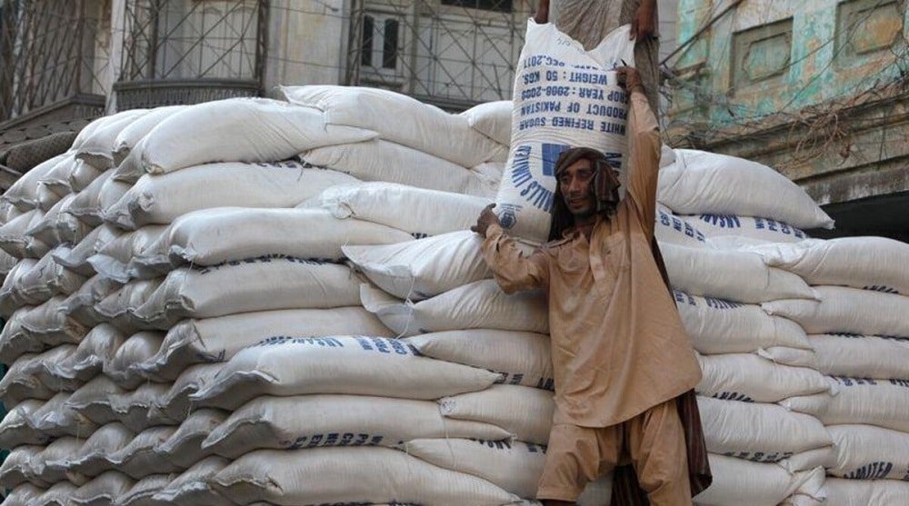 Pakistan Surplus Sugar Tender Draws Zero Bids as Reserve Price Overshoots World Market Worker carrying sacks of refined sugar as the Pakistan surplus sugar tender draws zero bids