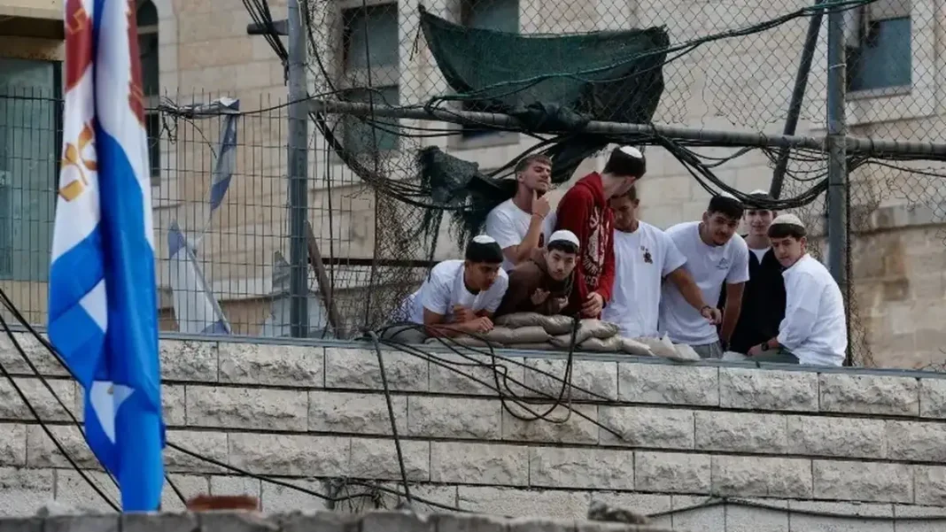 Israeli Settlers Attack European Diplomats, Beat Up French Mayor Israeli settlers beat French mayor - settlers at a West Bank settlement fence