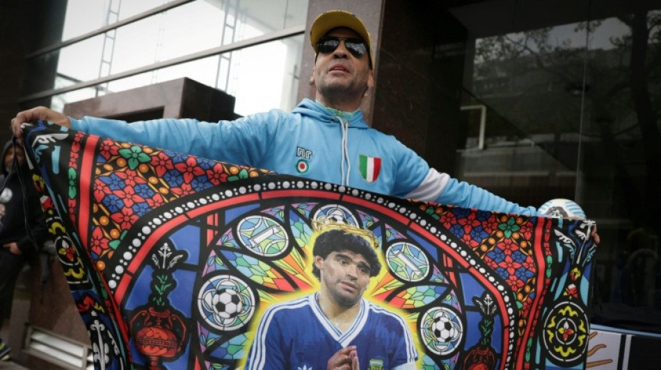 Prosecutors seek up to 12 years in Maradona death trial Supporter holding a Maradona banner as the Maradona death trial continues in Buenos Aires