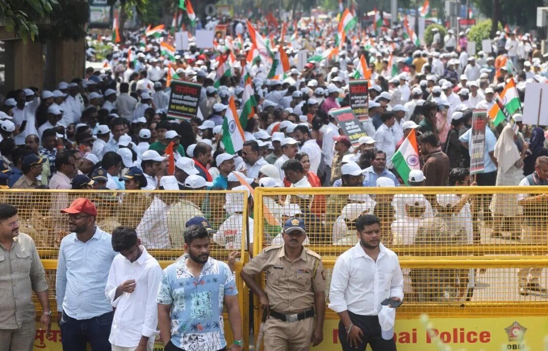 India brings in thousands of police as ‘Cockroach’ movement vows Saturday march in Delhi Protesters with Indian flags rally behind police barricades amid the India voter-roll protest