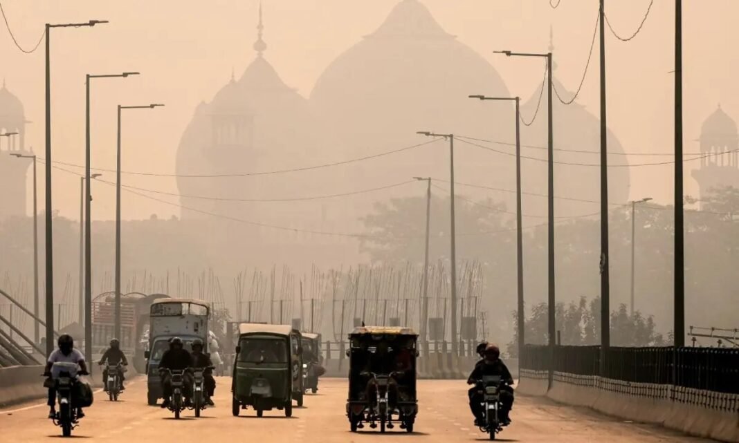 Lahore tops world’s most polluted cities again with ‘unhealthy’ air Commuters ride through smog in Lahore; Lahore most polluted city tops IQAir ranking again