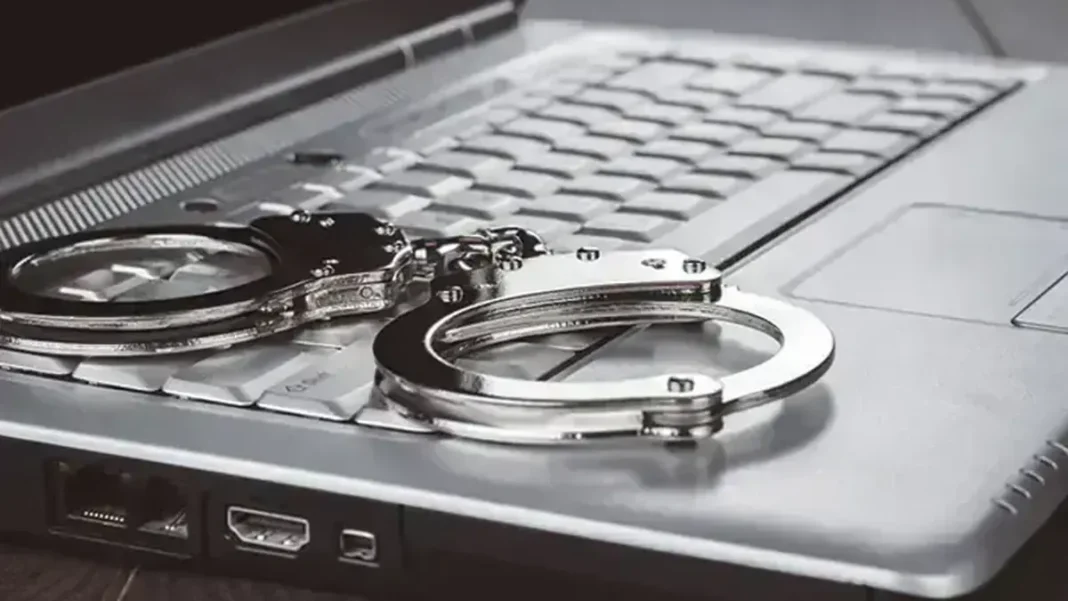 NCCIA seeks 300 officers from Punjab Police on deputation Handcuffs on a laptop keyboard - NCCIA 300 officers