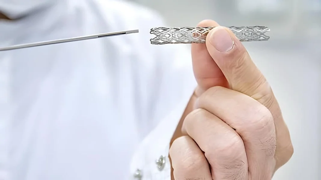 Faisalabad Hospital Faces Cardiac Stent Shortage A hand holding a cardiac stent, cardiac stent shortage
