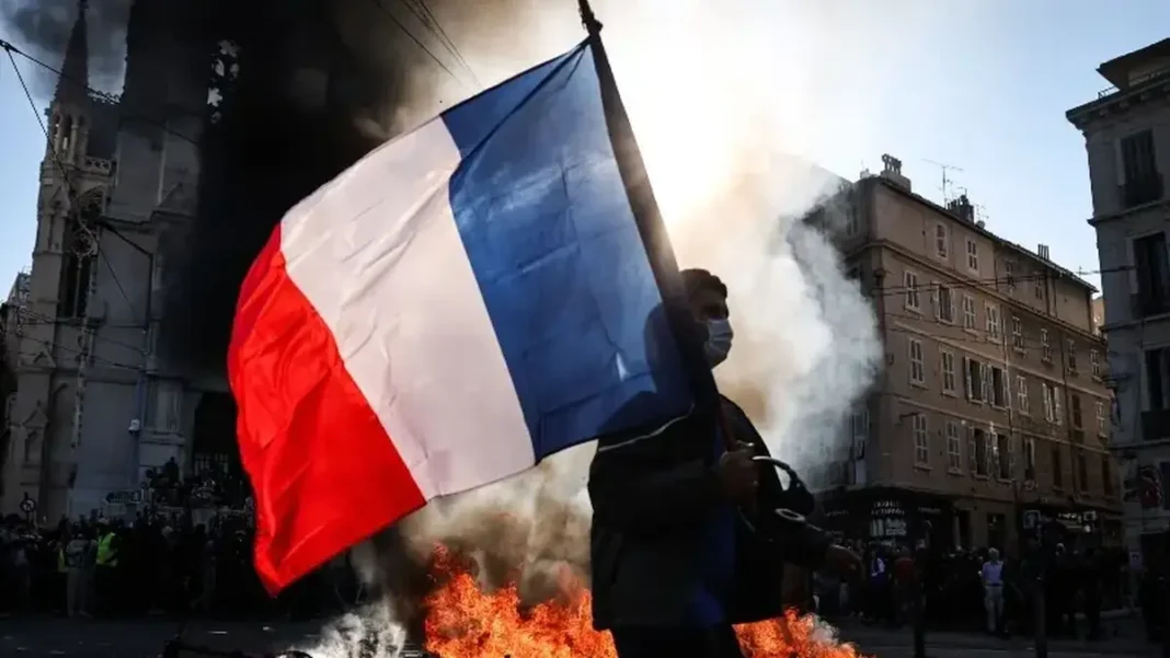 France Weekend Protests: 70,000 Police Deployed France weekend protests: French flag amid street protest