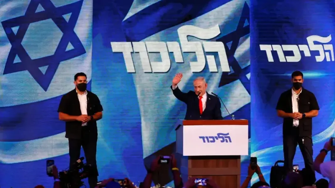 Netanyahu Bloc Leads Israel Count but Short of Majority Benjamin Netanyahu at a Likud podium — Netanyahu bloc leads