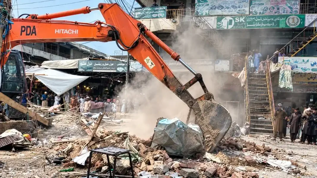 Peshawar Ring Road Demolitions Clear 450 Sites A PDA excavator clears rubble during Peshawar Ring Road demolitions.