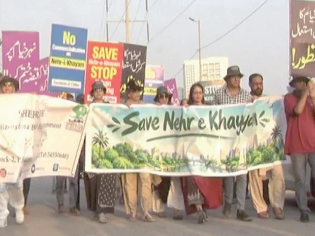 Karachi Residents Warn Nehr-e-Khayyam Is Shrinking Residents hold a Save Nehr-e-Khayyam banner in Karachi - Nehr-e-Khayyam narrowing Karachi