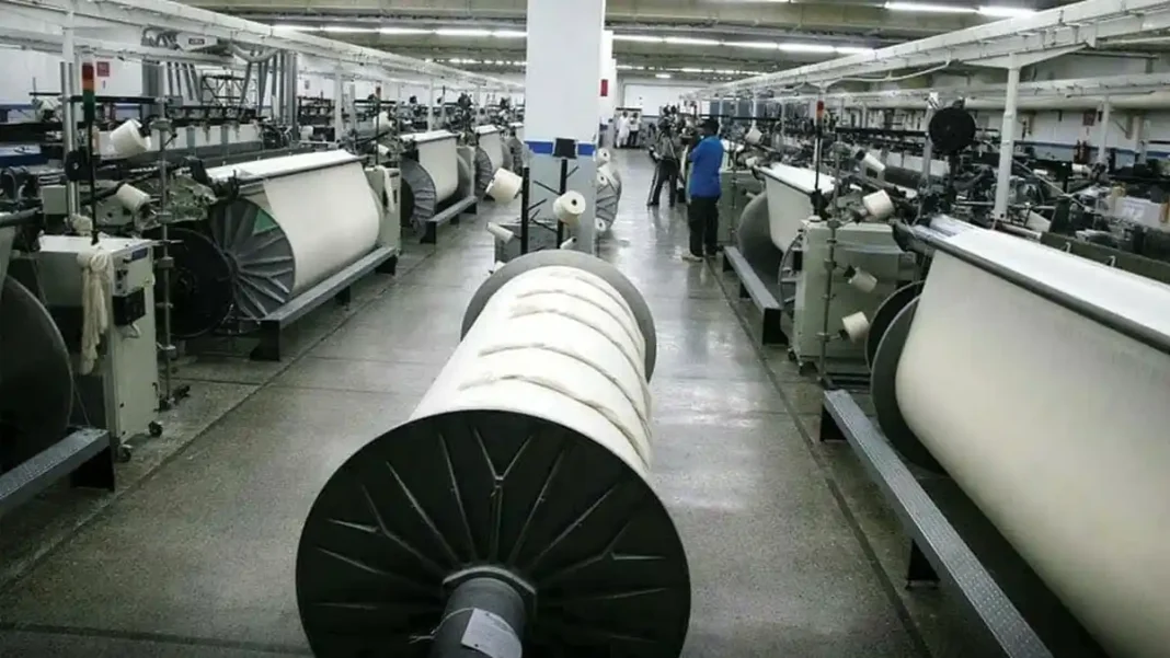 PTEA Warns SBP Rate Hike Will Hit Exports Rows of textile machinery in a mill, illustrating the PTEA SBP rate hike reaction