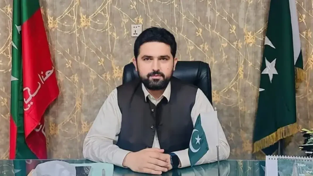 PTI Affirms Afridi Remains KP Chief Minister Sohail Afridi seated at a desk with PTI and Pakistan flags — PTI affirms Afridi