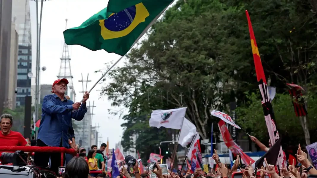 Brazil Runoff Vote Pits Lula Against Bolsonaro President Lula waves a flag at a campaign rally in Sao Paulo - Brazil runoff vote