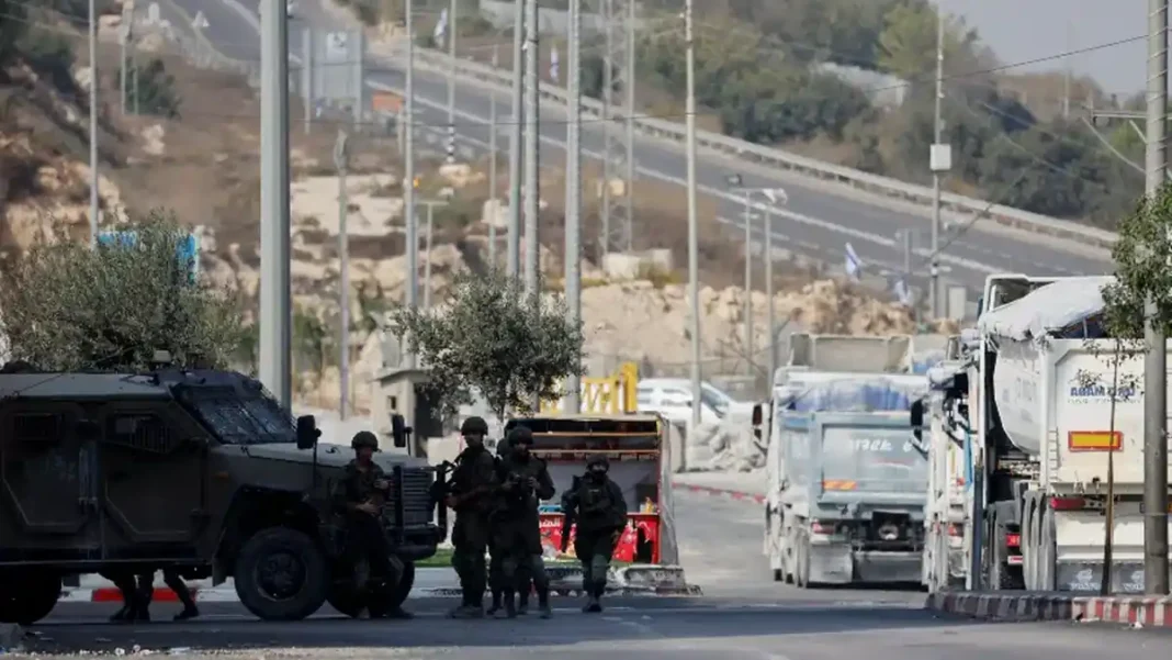 UN Warns Hebron Operation Raises Ethnic Cleansing Fears Israeli soldiers and an armoured vehicle at a roadblock, illustrating the Hebron ethnic cleansing concerns