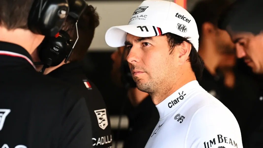 Sergio Perez Extends Cadillac Deal Until 2029 Sergio Perez in Cadillac cap with team engineers — Sergio Perez Cadillac 2029