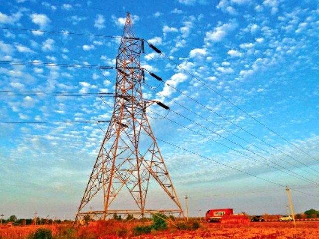 K-Electric Warns of Possible Load Management During Evening and Night Peak Hours K-Electric load management - electricity transmission tower against a blue sky